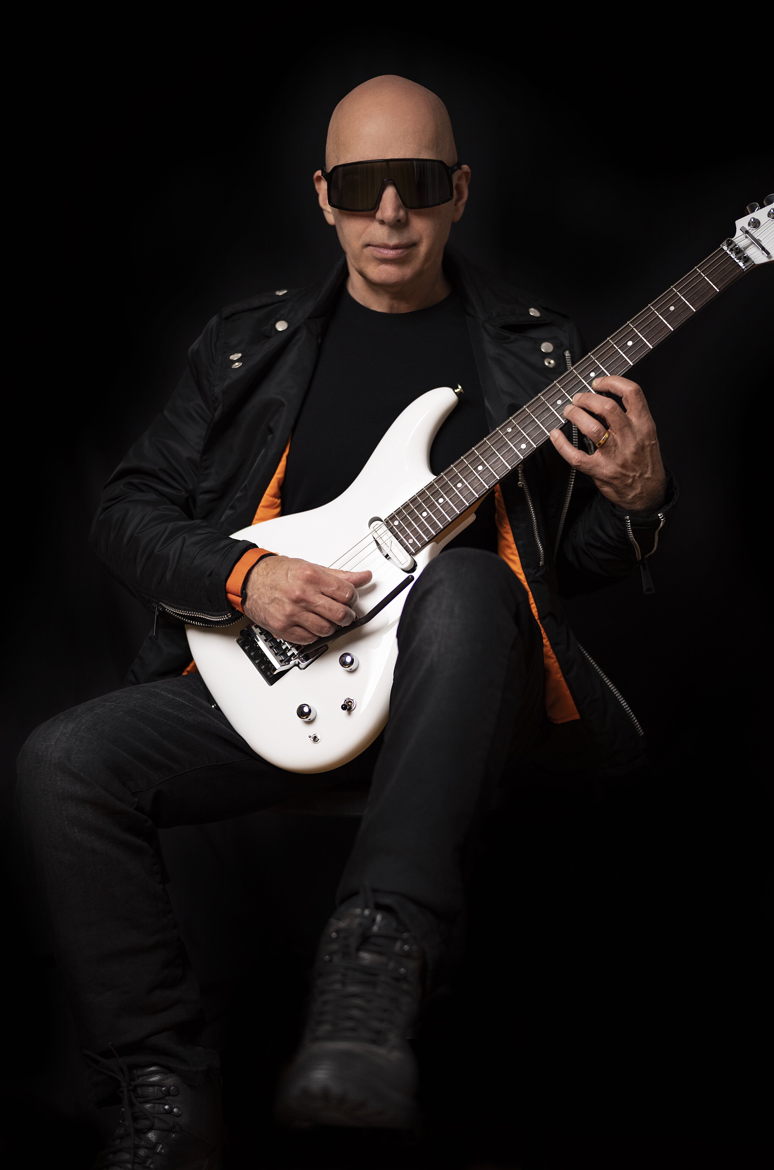 Joe Satriani posing with guitar